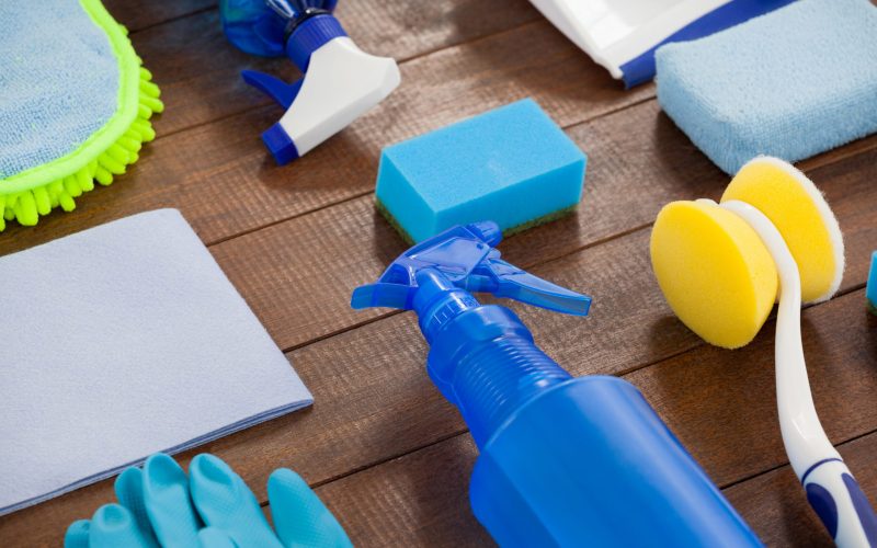 Set of cleaning equipment arranged on wooden floor